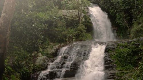 Beautiful Waterfall Flowing Through Lush Green Forest