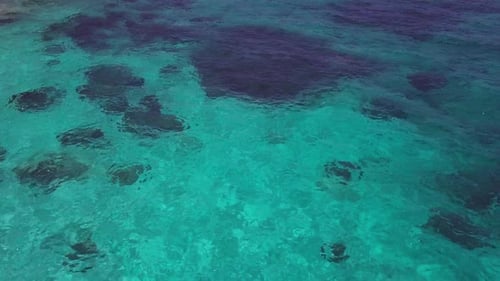Sea Surface Ripple at Sunlight with Transparent Clear Water and Visible Sandy Bottom with Underwater