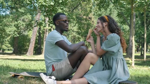 Couple Sharing Ice Cream in Sunny Park