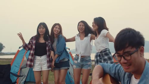 Group of Asia best friends teenagers give high five and dancing enjoy with guitar music.