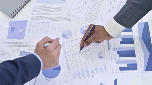Close Up of Hands of Business Team Working on Documents