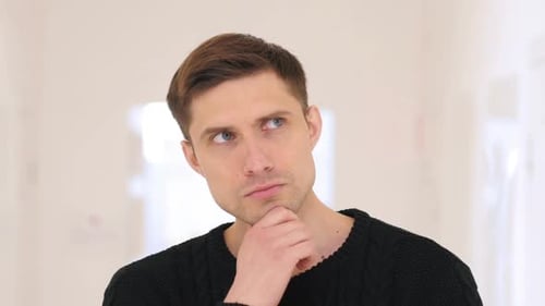Portrait of Thinking Man Brainstorming Sitting in Office