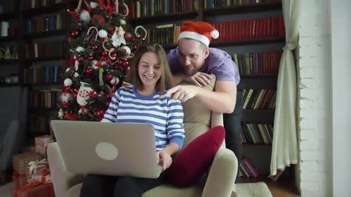 Couple Using Laptop at Home During Christmas