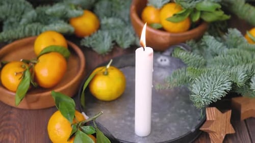 Candle with Tangerines and Pine Branches