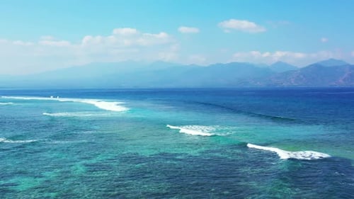 Aerial top down scenery of idyllic resort beach wildlife by blue sea with white sandy background of