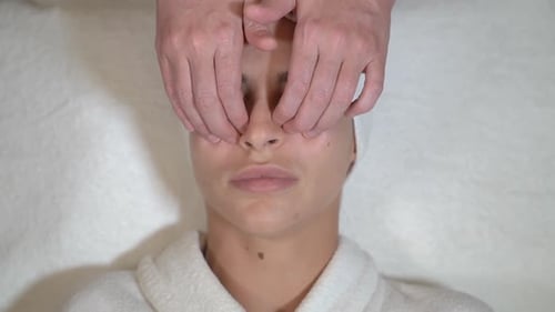 Woman Receiving Facial Massage Close Up Overhead Shot