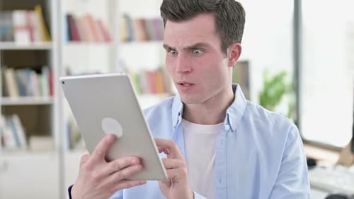Man Reacts to Tablet in Surprise