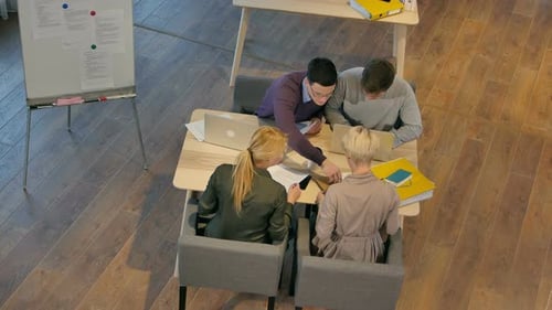 Business Team Collaborating on a Project from Above