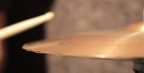 Golden Cymbal Being Struck in Close Up