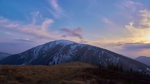 Beautiful evening sunset over the misty snowy mountains in the wild Slovak countryside,