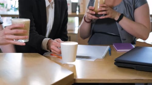 Business Meeting Over Coffee in Bright Cafe