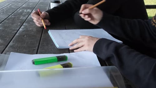 Men Doing Homework At Bench