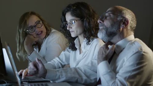 Content Business People Working Together in Dark Office