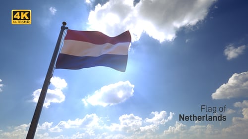 Waving Flag Against Blue Sky With Sun