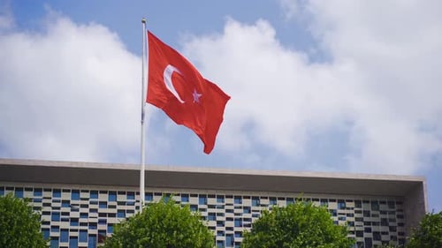 Turkish Flag Waving in Front of Modern Building