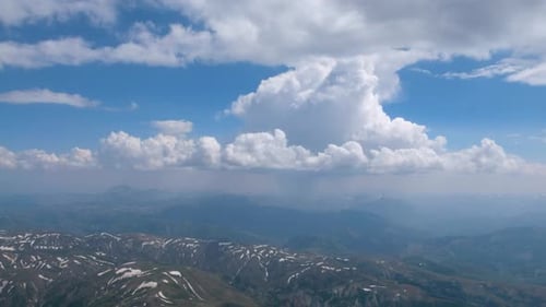 Snowy Mountain Range Under Cloudy Sky