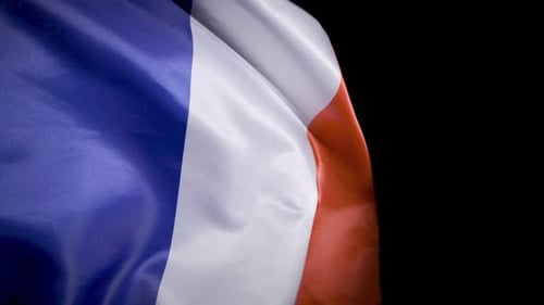 French Flag Waving Against Black Background