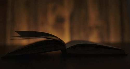 Pages Turning in Book in the Dark