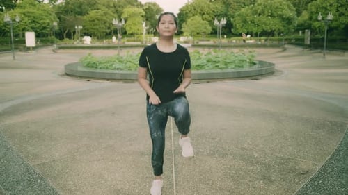 Asian woman exercise in park outdoor with new normal in COVID-19 situation