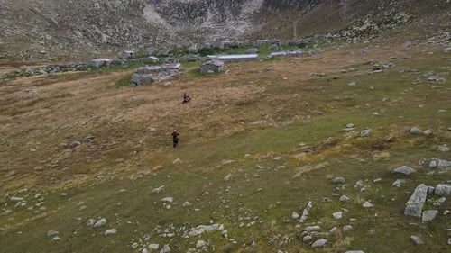 Rugged Mountain Landscape with Motorbike and Walker