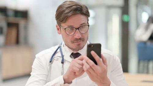 Doctor Using Smartphone in Hospital Setting