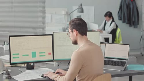 Male Engineer Developing Mechanism Scheme in Office