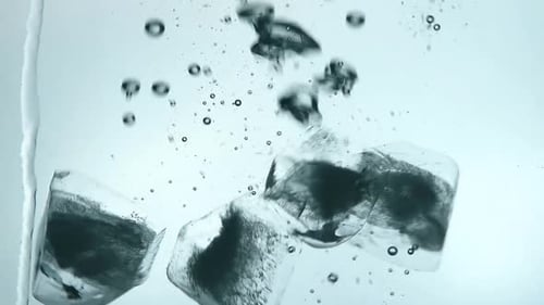 Ice Cubes Falling into Clear Water