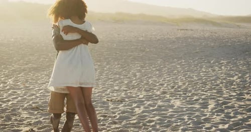 African American couple hugging at beach