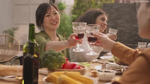 Two Diverse Women Drinking Wine in Cafe