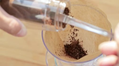 Coffee Grounds Pouring into Filter for Coffee Making