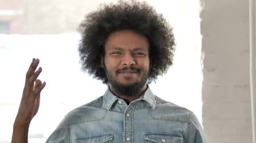 Man Gestures and Touches his Face