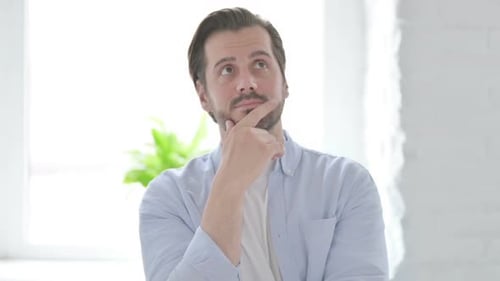Portrait of Thinking Young Man Getting New Idea