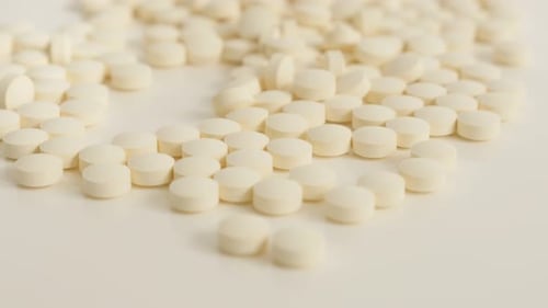 Pile of White Tablets Close Up