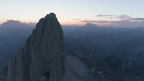 Aerial view stunning golden sunrise disappearing behind sharp Tre Cime mountain summit