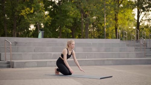 Fitness Woman Practice Yoga Exercises On Mat Outdoor City Street Sunlight Background