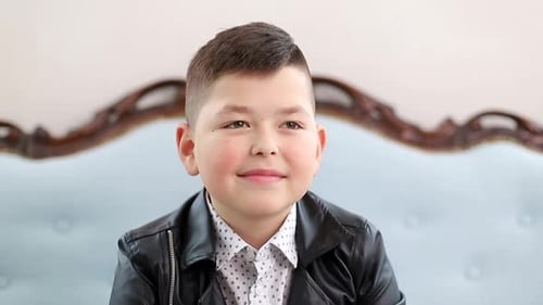 Smiling Boy Wearing a Leather Jacket Indoors