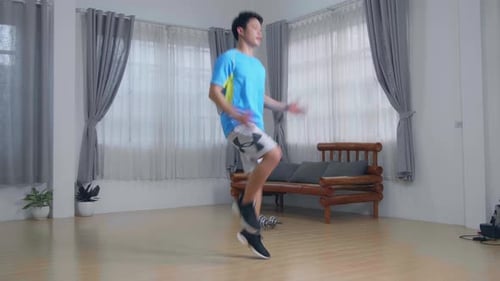 Man Energetically Jogging In Place At Home In His Living Room