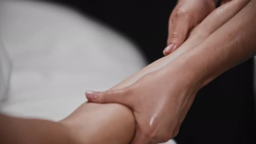 Young Woman Receiving a Massage in the Studio Soft Massaging Her Forearm