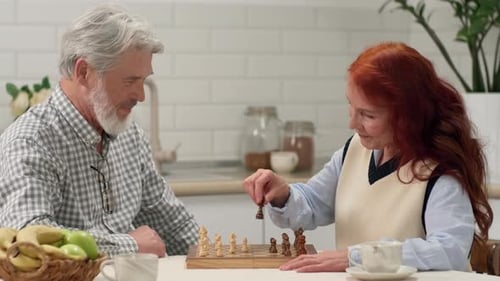 Mature Couple Enjoying Chess Game at Home