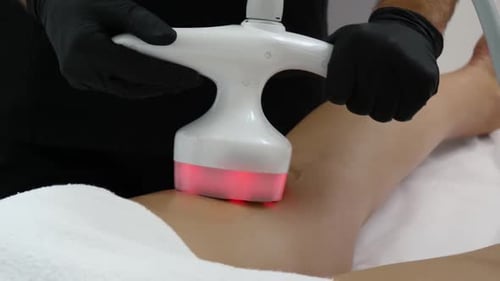 Medical Professional Treats Patient with Light Machine