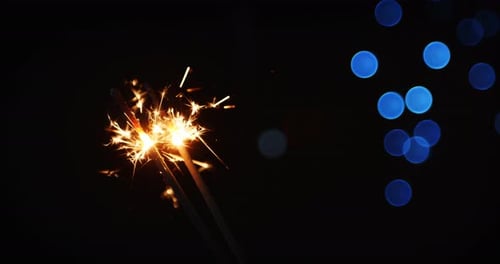 Sparkling Sparklers with Blue Bokeh Background