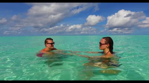 Two lovers suntan on idyllic sea view beach adventure by blue sea and white sandy background of the