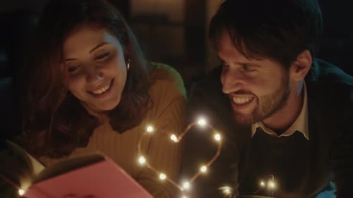 Loving Couple Reading Together at Night