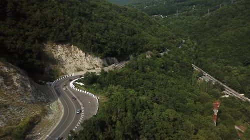 Flying Over the Mountains, Along Which the Road Goes with Cars
