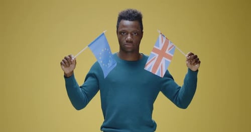 Man Holding European Union and UK Flags
