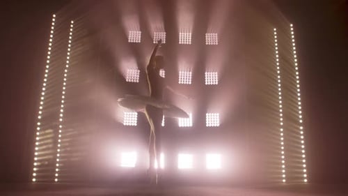 Elegant Ballerina Dances Under Bright Stage Lights