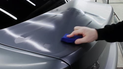 Detailer Applies Protective Coating to Car Paint
