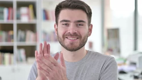 Porträt eines jungen Mannes, der für das Team klatscht und applaudiert