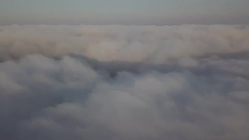 View From a Drone on a Sea of Clouds to the Horizon at Dawn