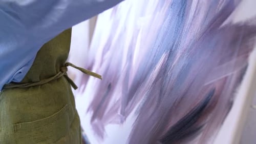 Artist Painting With a Brush on a Canvas